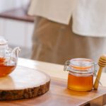 Tea Culture - Teapot and a Honey Jar with Spices on a Wooden Table