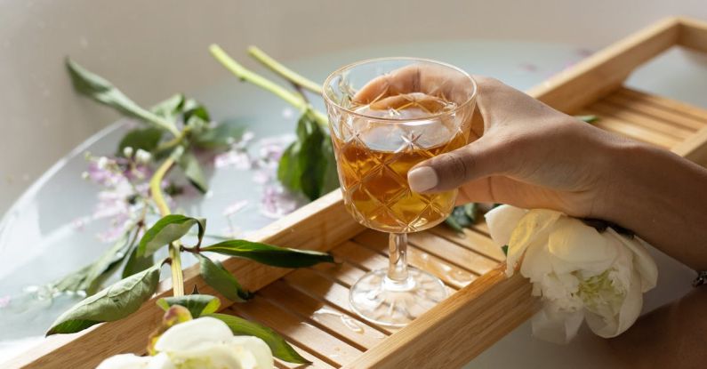 Luxury Spa - Woman with wineglass and flowers in bathtub